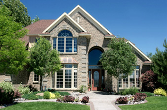 A large brick house with a nice lawn.
