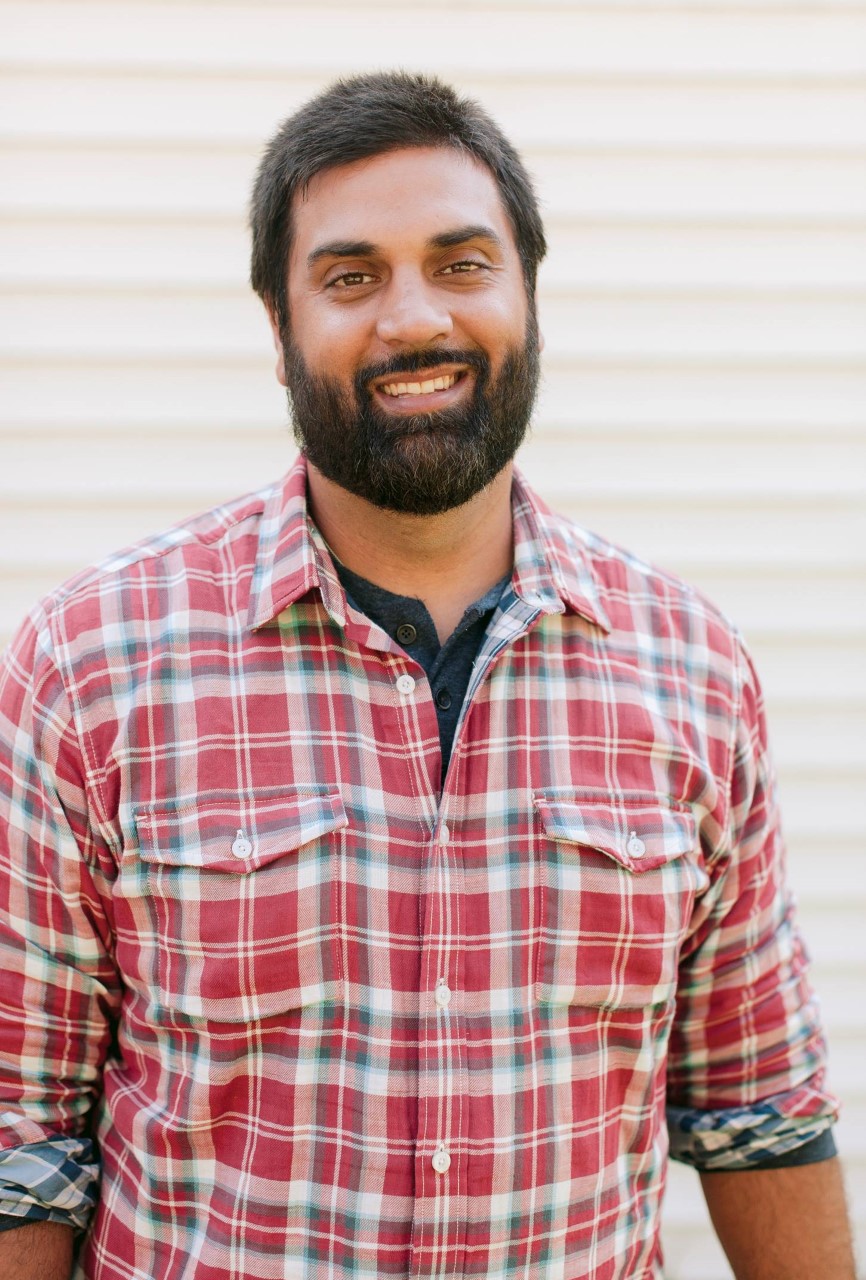 A man in a red and white plaid shirt.